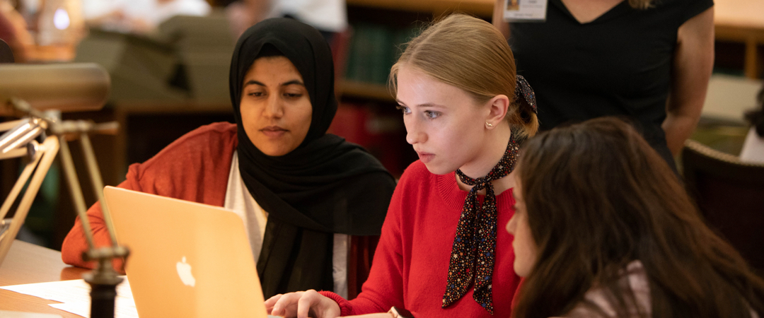 Three women at a laptop