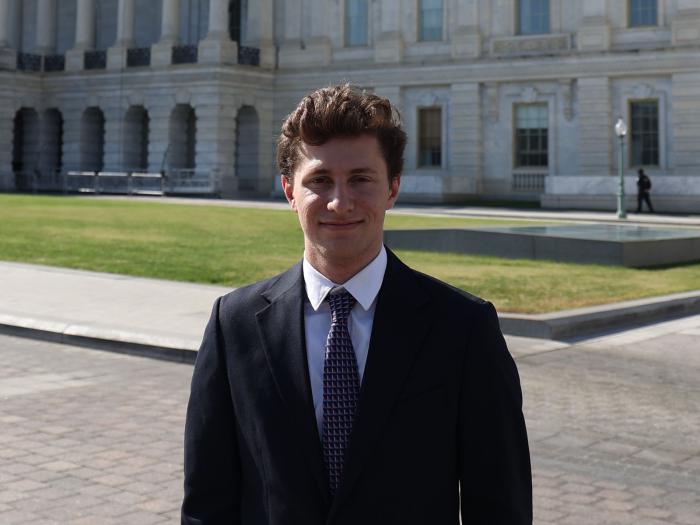 Aiden Linkov posing for a photo in front of the U.S. Capitol.