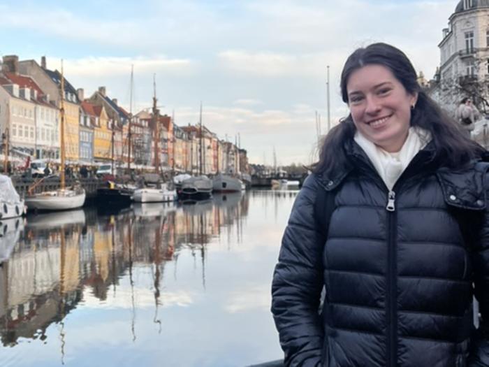 Maeve Richardson posing for a photo in front of a waterway.