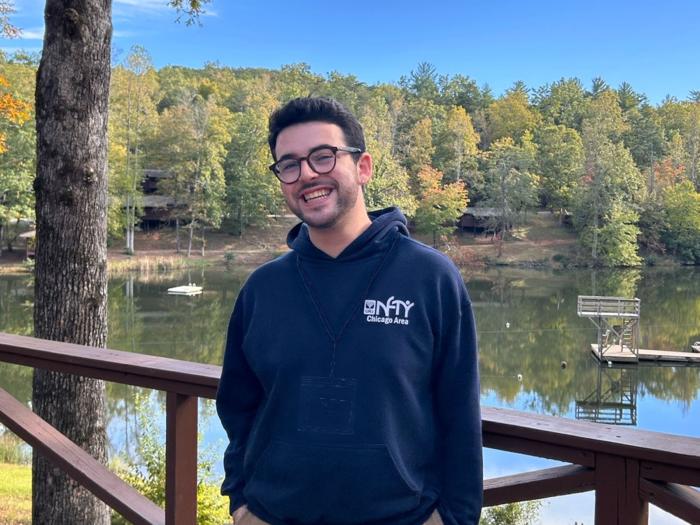 Noah Shapiro posing for a photo on a lake.
