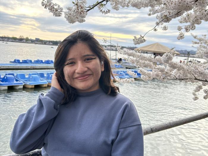 Paola Sigüenza Barragán at the tidal basin during peak bloom.