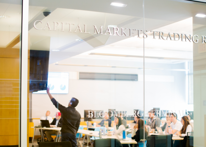 Students seen in a classroom through a glass wall