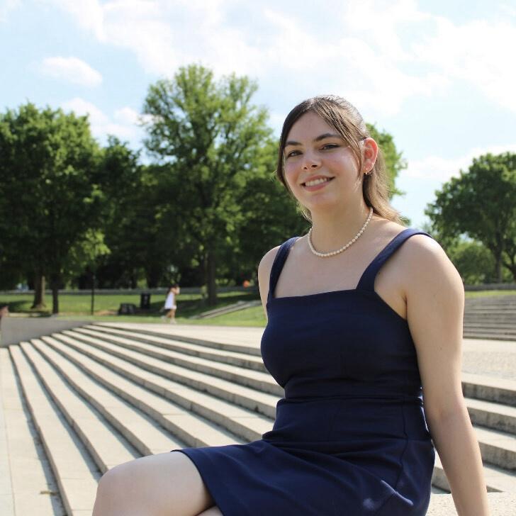 Emily Linder sitting on outdoor steps.