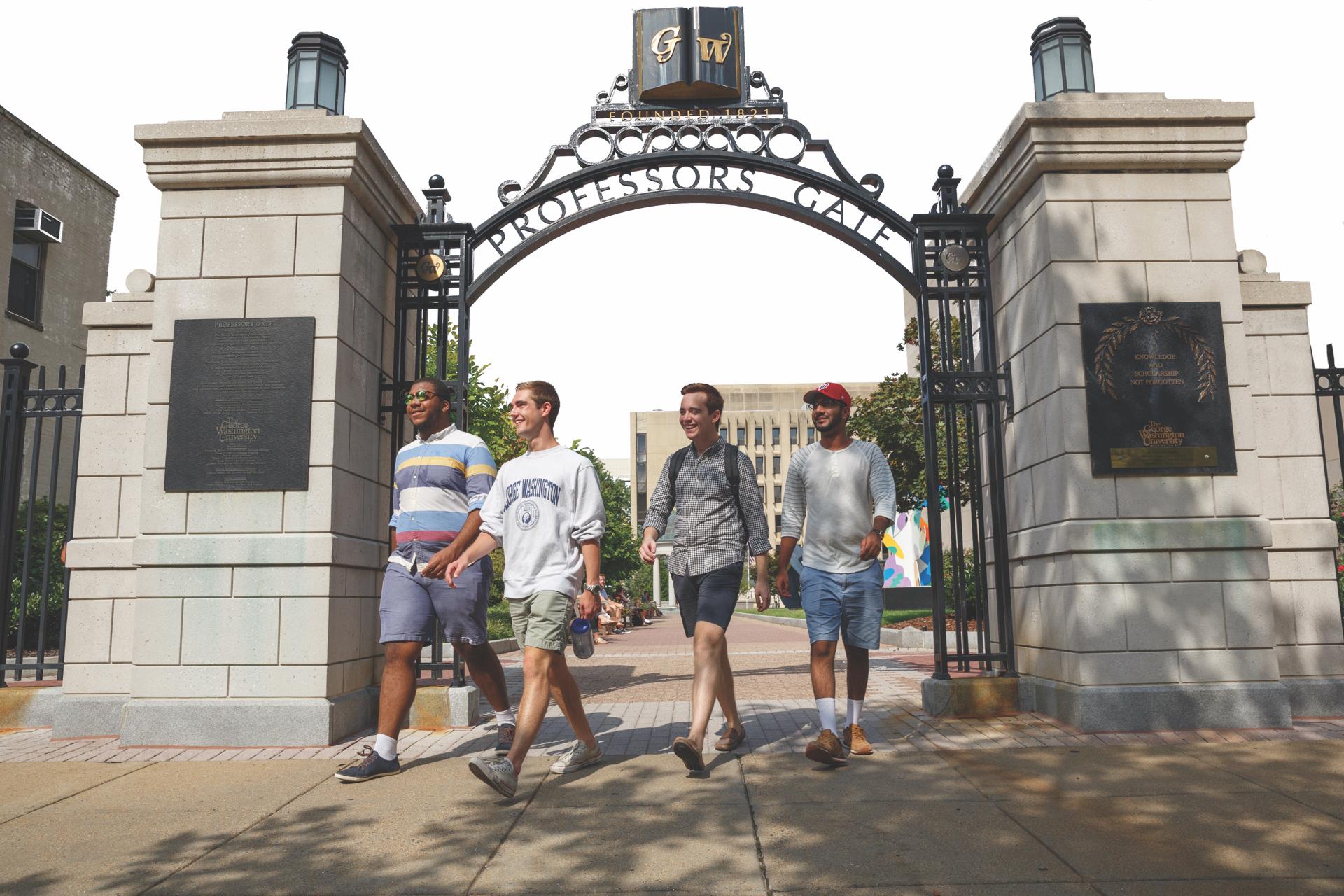 Students walking under gate